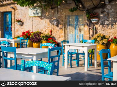 Tables and chairs setup in a traditional Italian restaurant in Marzamemi - Sicily during a sunny day