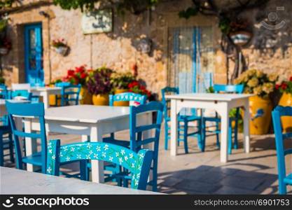 Tables and chairs setup in a traditional Italian restaurant in Marzamemi - Sicily during a sunny day