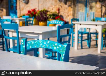 Tables and chairs setup in a traditional Italian restaurant in Marzamemi - Sicily during a sunny day