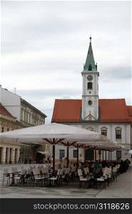 Tables on the square and church in Varazhdin, Croatia