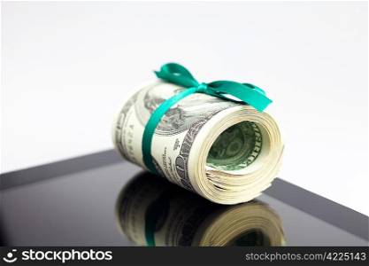 tablet and tube of dollars isolated on white