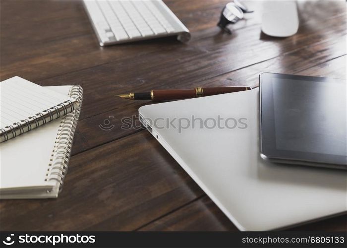 tablet, computer notebook on wooden office desk