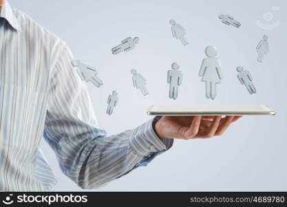 Tablet in hand with symbols. Close up of businessman hand holding tablet and glass symbols