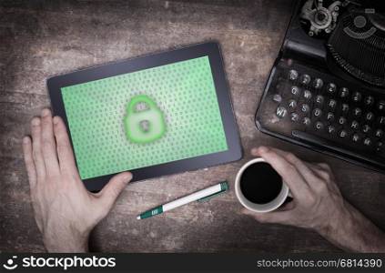 Tablet on a desk, concept of data protection, green