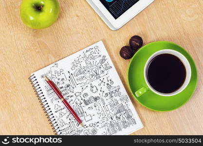 Tablet pc cup of coffee and notepad at table. Work place