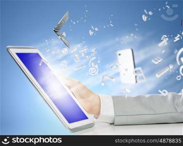 Tablet pc in hand. Close up image of human hand holding tablet pc