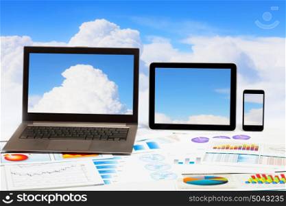 Tablet PC laptop mobile phone. Image of ipad laptop and mobile phone with clouds image