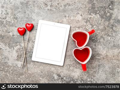 Tablet PC with Red Heart Decoartion and Tea Cups. Valentines Day concept with space for Your text and picture