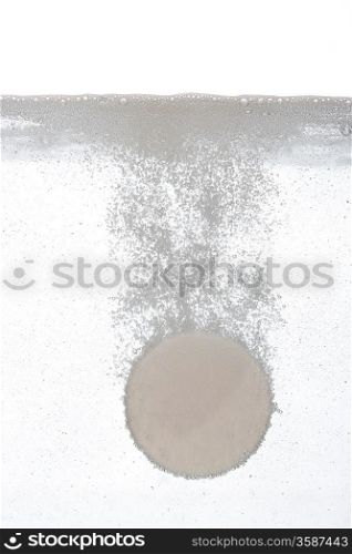 Tablet sinking in water, close-up