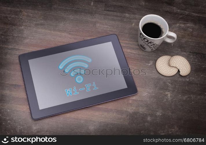 Tablet with Wi-Fi connection on a wooden desk,vintage setting