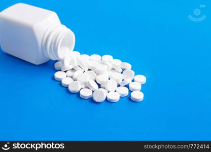 Tablets of Paracetamol on blue background. Copy space