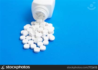 Tablets of Paracetamol on blue background. Copy space