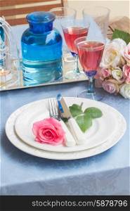 Tableware for dinner with st of plates, cutlery and flowers
