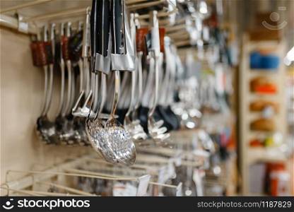 Tableware on the shelf closeup, houseware store, nobody. Home goods in market, kitchenware supply shop products. Tableware on the shelf closeup, houseware store