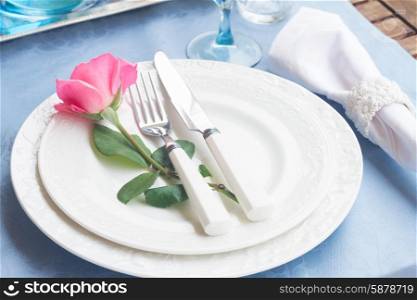 Tableware - set of plates, cups and utencils with rose