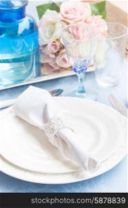 Tableware - set of plates, cups, utencils and flowers