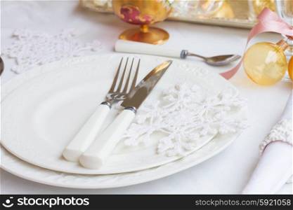 Tableware set. Tableware for christmas - set of plates and utencils on white tablecloth