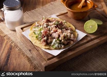 Taco de Carnitas. Cornmeal tortilla with deep fried pork. Traditional Mexican appetizer commonly accompanied by cilantro, onion and hot sauce.