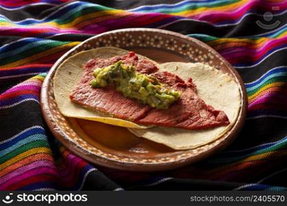 Tacos de Cecina Enchilada con Guacamole. Salted, sun-dried pork or beef meat, seasoned with various spices and chili peppers, usually eaten in tacos