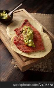 Tacos de Cecina Enchilada con Guacamole. Salted, sun-dried pork or beef meat, seasoned with various spices and chili peppers, usually eaten in tacos