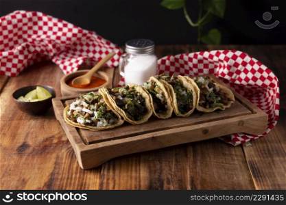 Tacos de Suadero. Fried meat in a corn tortilla. Street food from CDMX, Mexico, traditionally accompanied with cilantro, onion and spicy red sauce 