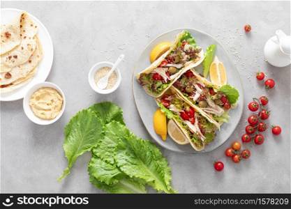 Tacos with chicken meat, salad and vegetables