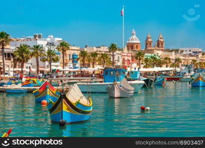 Taditional eyed boats Luzzu in Marsaxlokk, Malta. Traditional eyed colorful boats Luzzu in the Harbor of Mediterranean fishing village Marsaxlokk, Malta