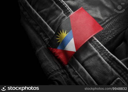 Tag on dark clothing in the form of the flag of the Antigua and Barbuda.. Tag on dark clothing in the form of the flag of the Antigua and Barbuda