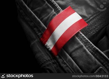 Tag on dark clothing in the form of the flag of the Austria.. Tag on dark clothing in the form of the flag of the Austria