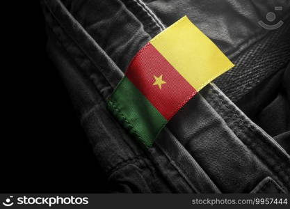 Tag on dark clothing in the form of the flag of the Cameroon.. Tag on dark clothing in the form of the flag of the Cameroon
