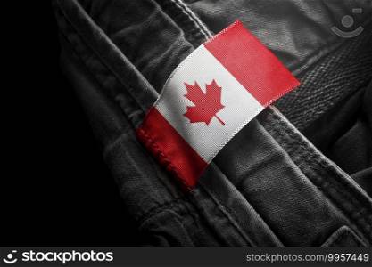 Tag on dark clothing in the form of the flag of the Canada.. Tag on dark clothing in the form of the flag of the Canada
