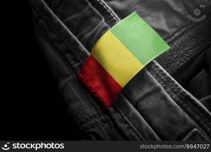 Tag on dark clothing in the form of the flag of the Guinea.. Tag on dark clothing in the form of the flag of the Guinea