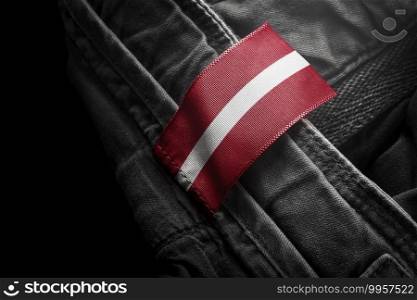 Tag on dark clothing in the form of the flag of the Latvia.. Tag on dark clothing in the form of the flag of the Latvia
