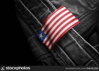 Tag on dark clothing in the form of the flag of the Liberia.. Tag on dark clothing in the form of the flag of the Liberia