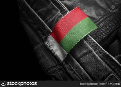 Tag on dark clothing in the form of the flag of the Madagascar.. Tag on dark clothing in the form of the flag of the Madagascar