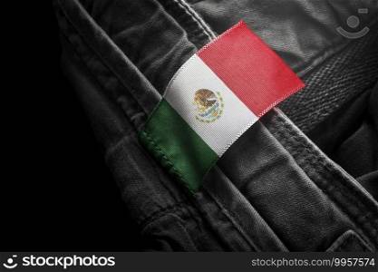 Tag on dark clothing in the form of the flag of the Mexico.. Tag on dark clothing in the form of the flag of the Mexico