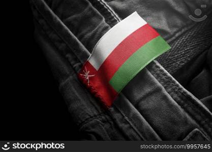 Tag on dark clothing in the form of the flag of the Oman.. Tag on dark clothing in the form of the flag of the Oman