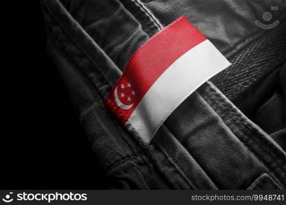 Tag on dark clothing in the form of the flag of the Singapore.. Tag on dark clothing in the form of the flag of the Singapore