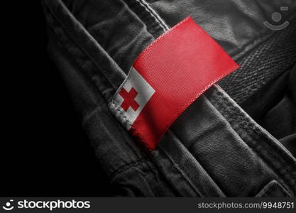 Tag on dark clothing in the form of the flag of the Tonga.. Tag on dark clothing in the form of the flag of the Tonga