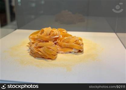Tagliatelle Italian Pasta on White Table with Flour