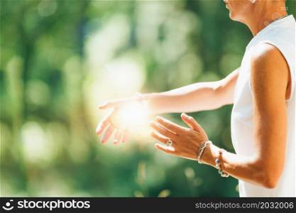 Tai Chi in Nature. Mature woman exercising Tai Chi in nature, Close up on hands. Tai Chi in Nature