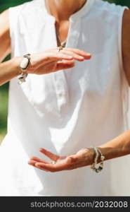 Tai Chi in Nature. Mature woman exercising Tai Chi in nature, Close up on hands. Tai Chi in Nature