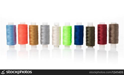 tailor needles and threads over white background