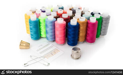 tailor needles and threads over white background