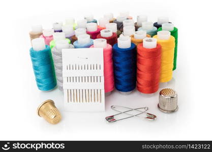 tailor needles and threads over white background