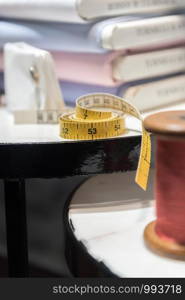 Tailor's Table with Red Thread and Tape Measure and Shirt Cloth Swatches