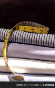 Tailor's Tape Measure and Fabric Swatches. Folded Mens Shirt Cloth
