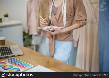 Tailor woman working in tailor shop Stylish Fashion designer tailor in workshop studio designing new collection Dressmaking and Creative
fashion collection