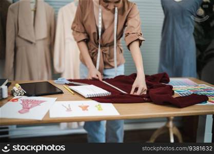 Tailor woman working in tailor shop Stylish Fashion designer tailor in workshop studio designing new collection Dressmaking and Creative
fashion collection
