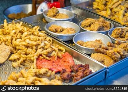 Taiwanese fried chicken and squid at traditional market in Taipei